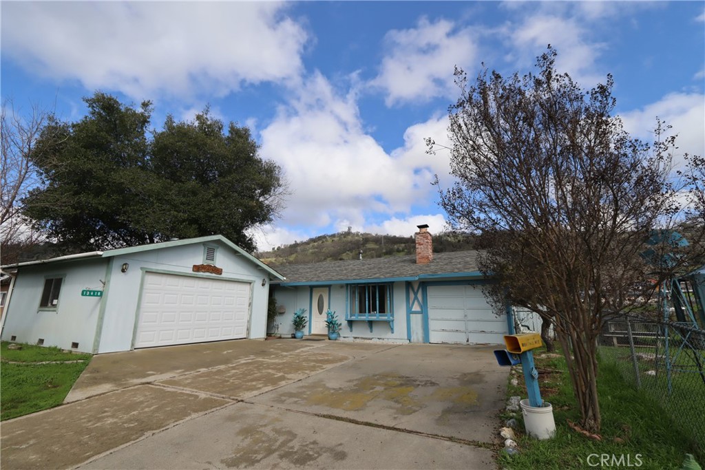 a view of a house with a backyard and a garage