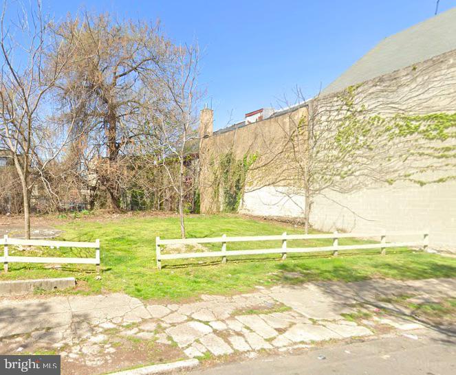 a view of a swimming pool with a yard