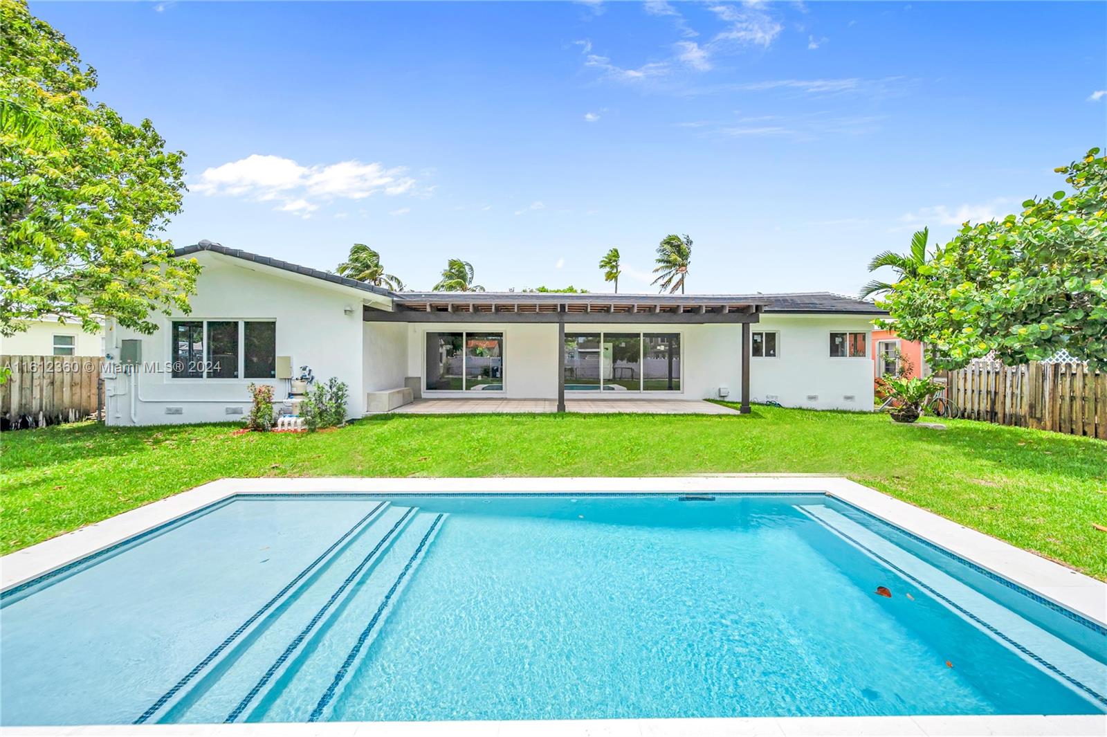 a view of house with a swimming pool