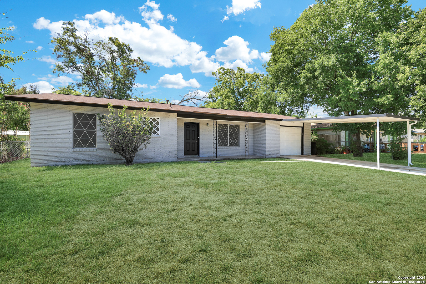 a view of an house with backyard space and garden