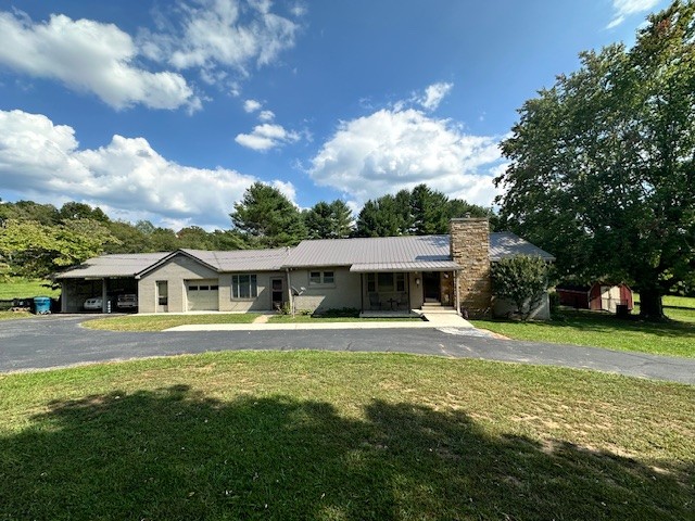 a front view of house with yard and trees