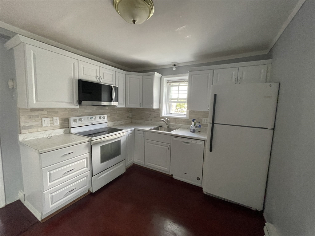 a kitchen with a refrigerator stove and sink