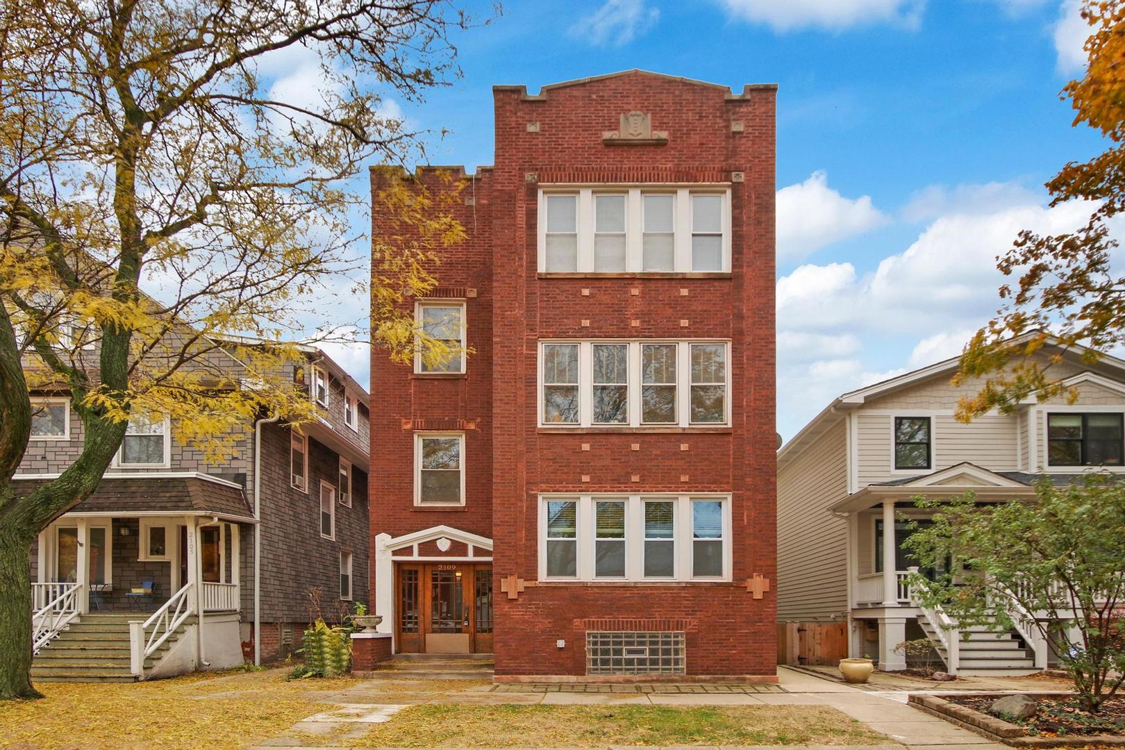 a front view of a building with a yard