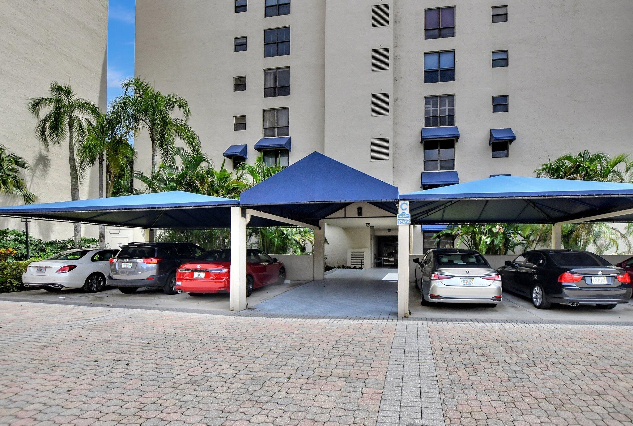 a car parked in front of a building with cars parked on the road