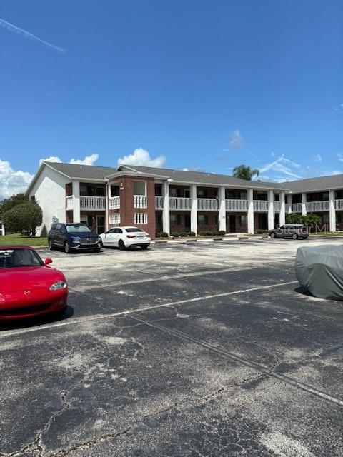 a front view of residential houses with cars parked