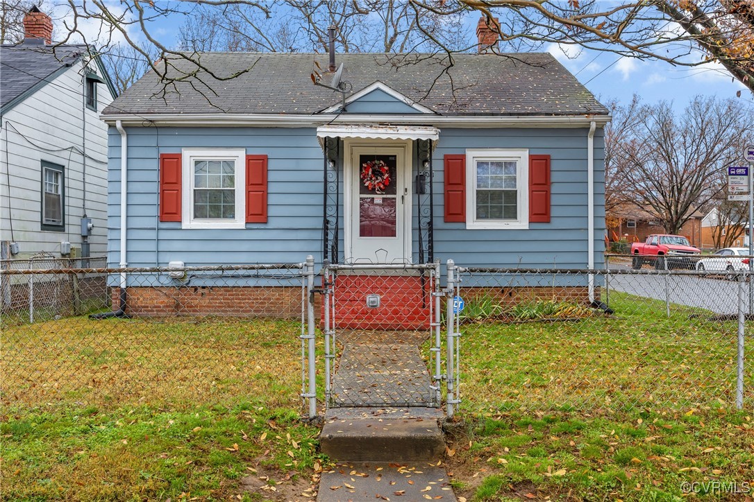 Bungalow-style house featuring a front lawn