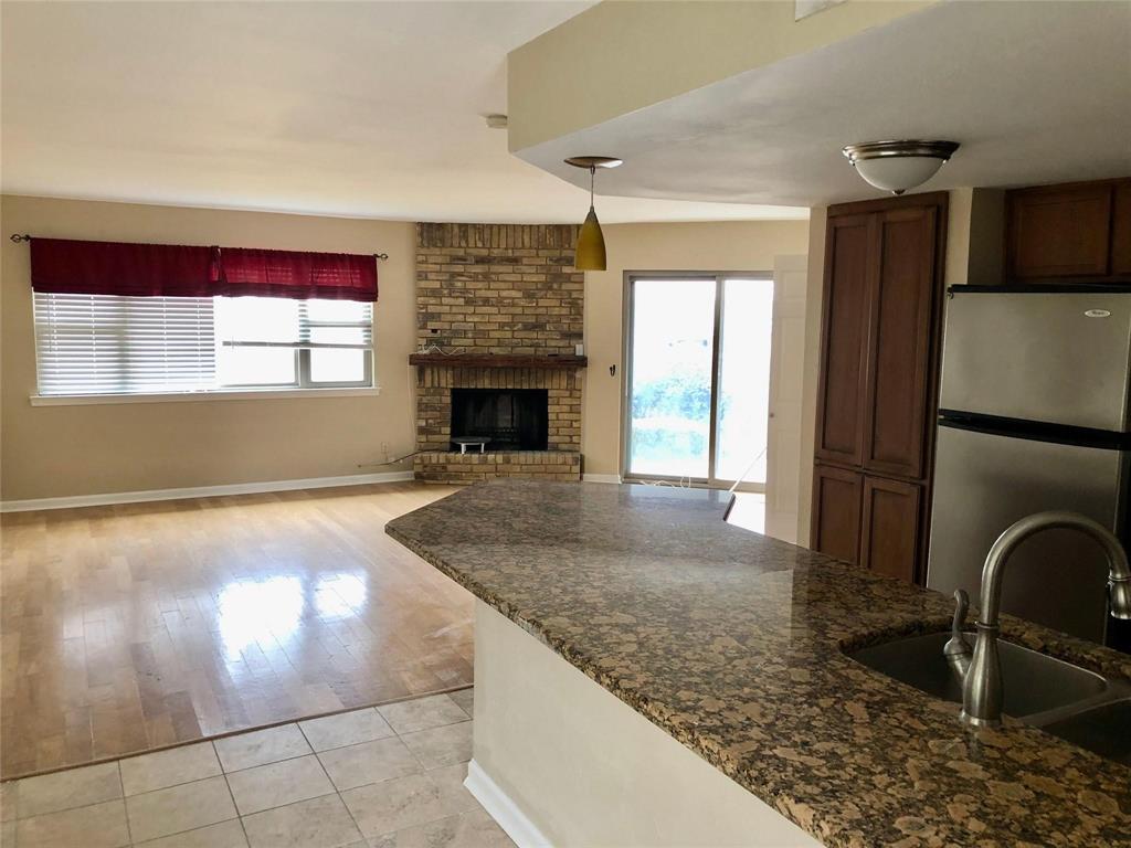 a view of a livingroom with a fireplace and window