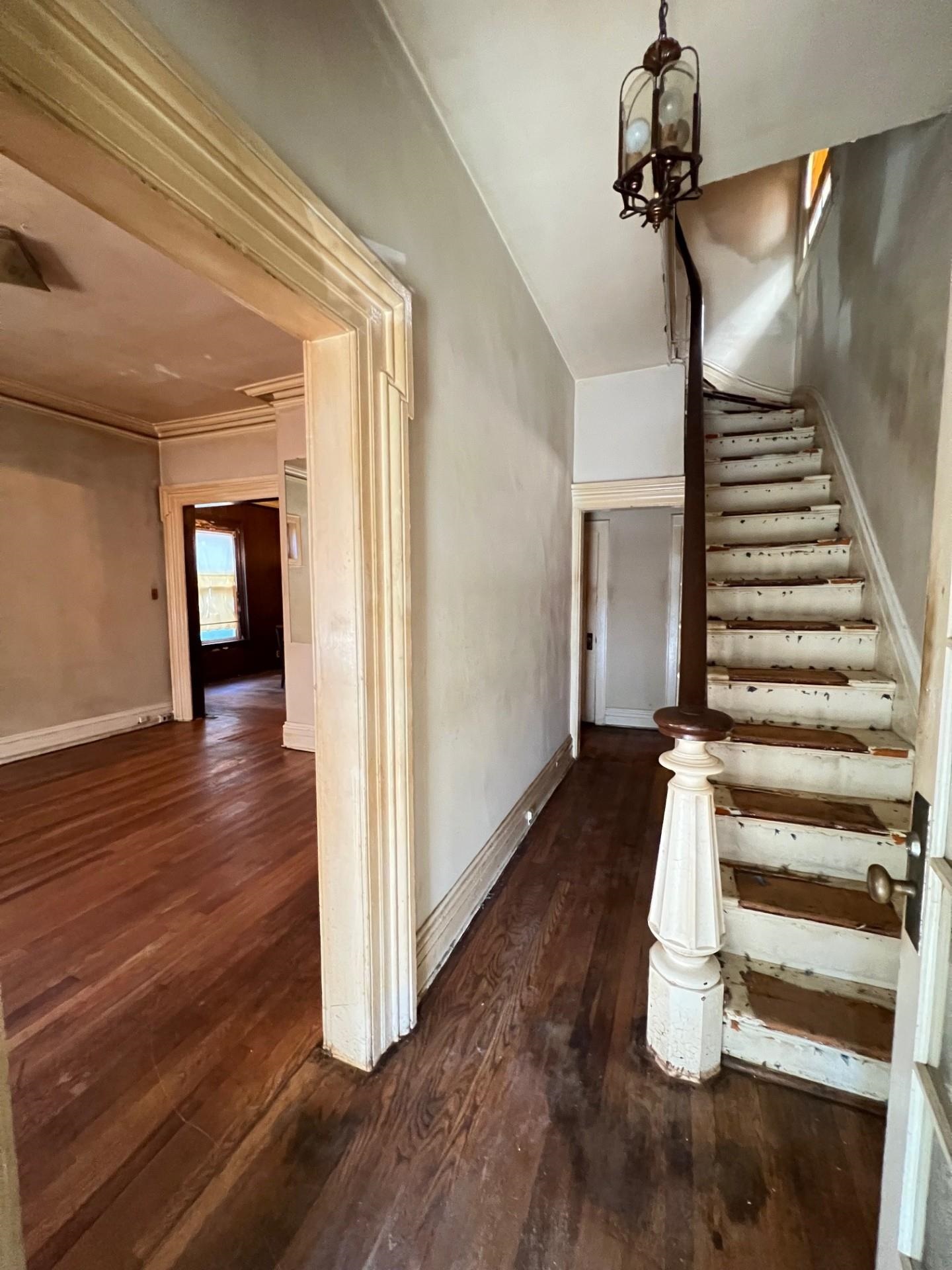 a view of entryway and hall with wooden floor