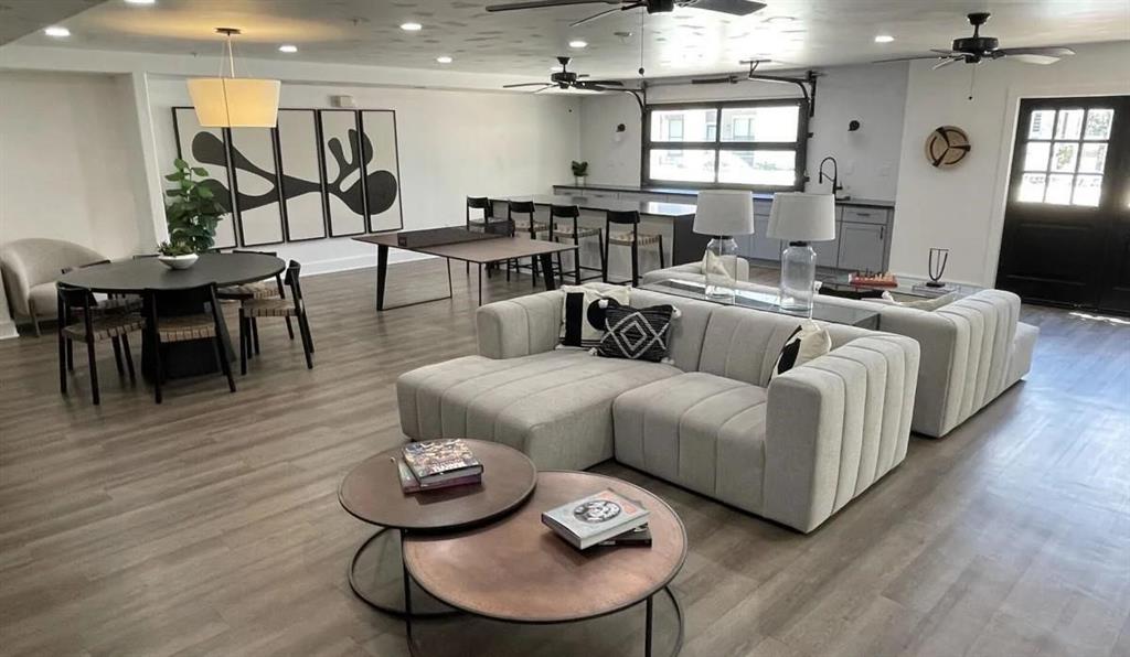 a living room with furniture a wooden floor and a chandelier