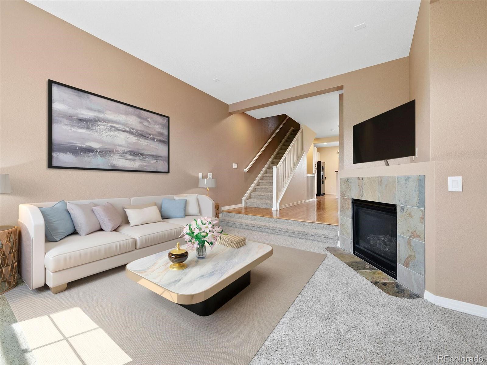 a living room with furniture a fireplace and a flat screen tv