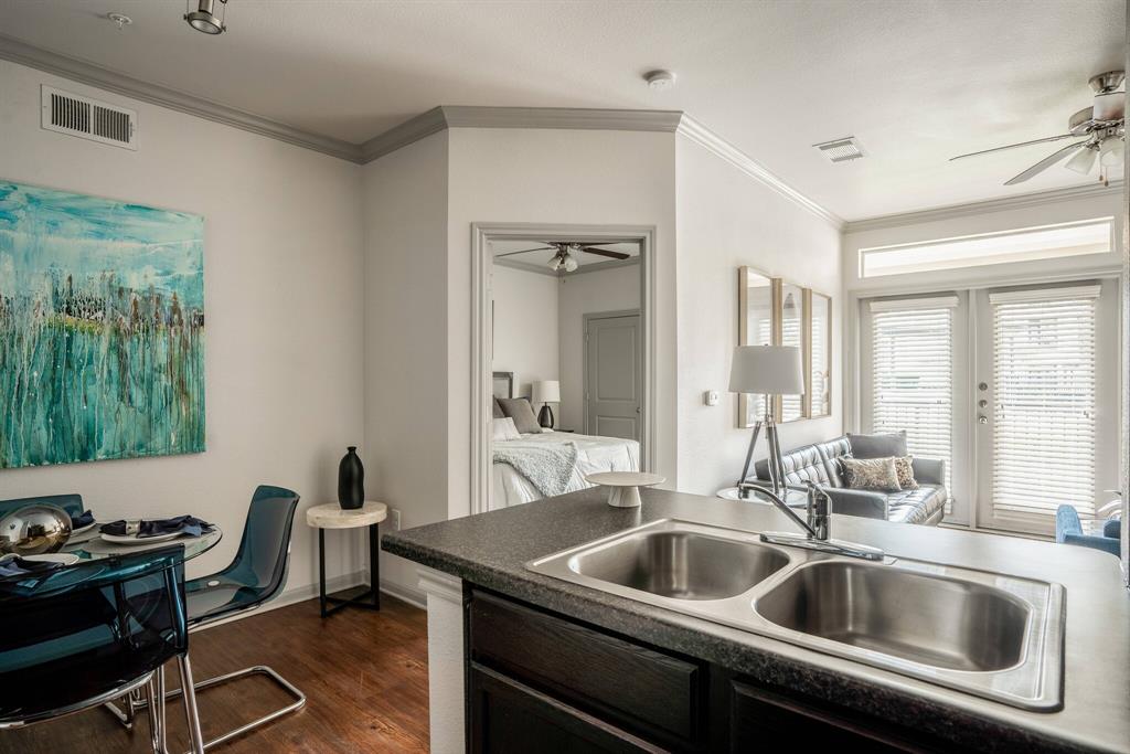 a kitchen with a sink and a refrigerator