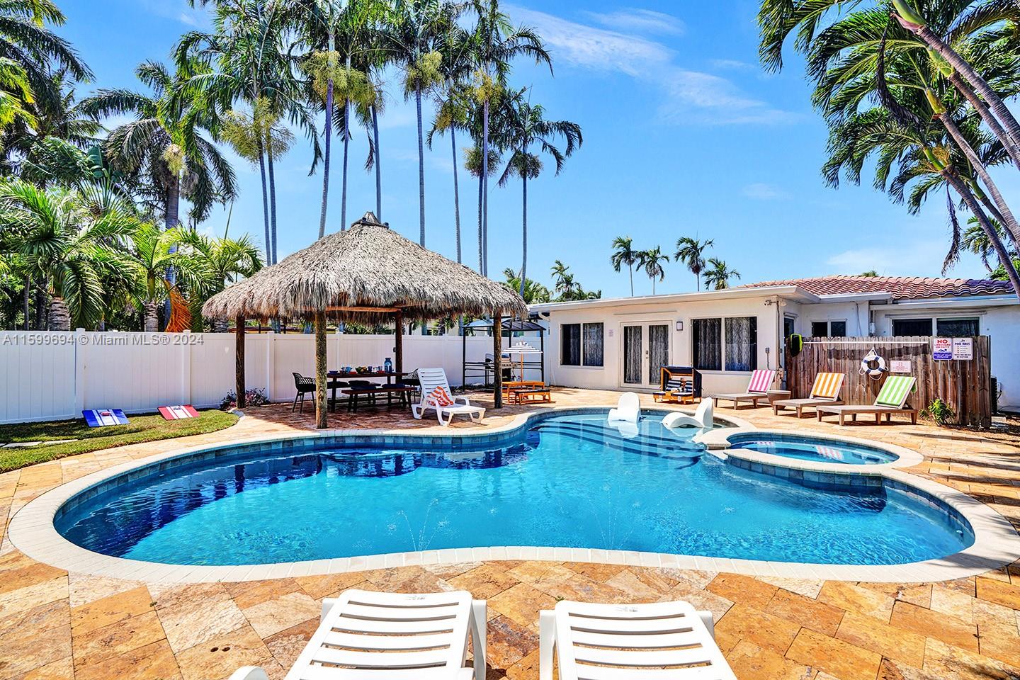 a view of a house with swimming pool and sitting area