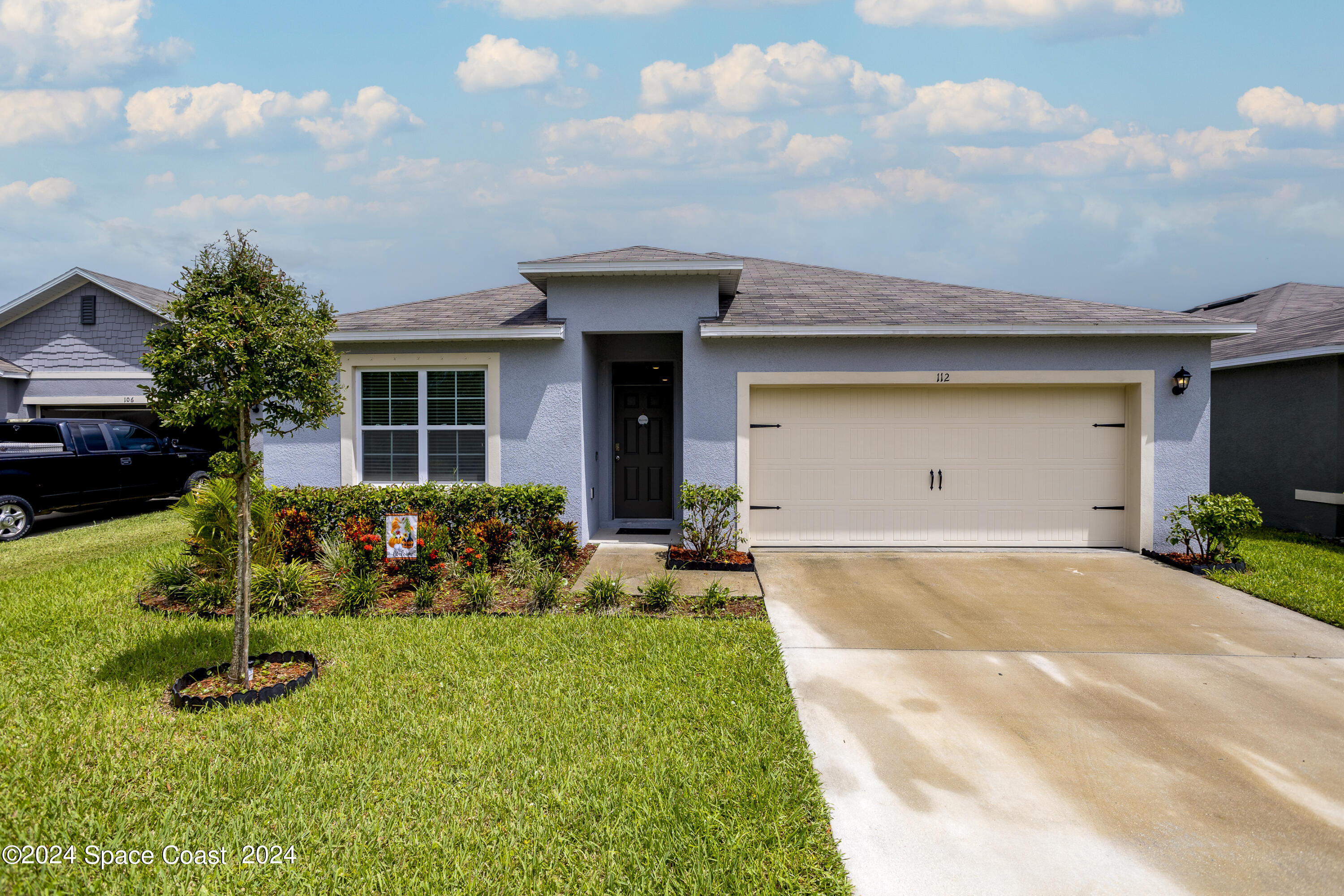 a front view of a house with a yard