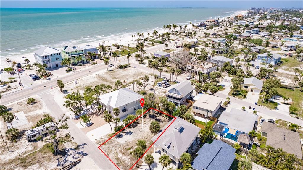 Aerial view with a water view and a view of the beach