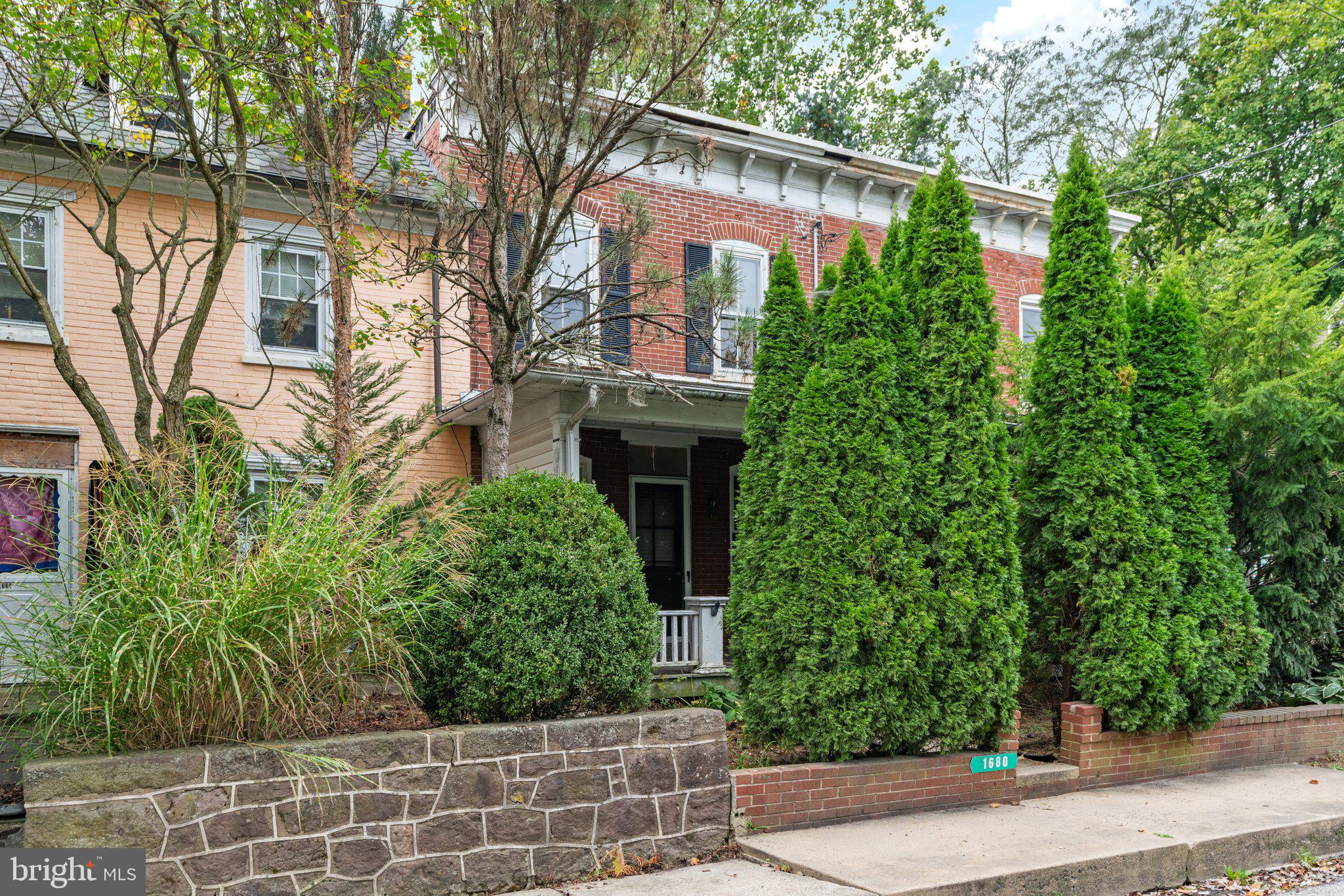 a front view of a house with plants