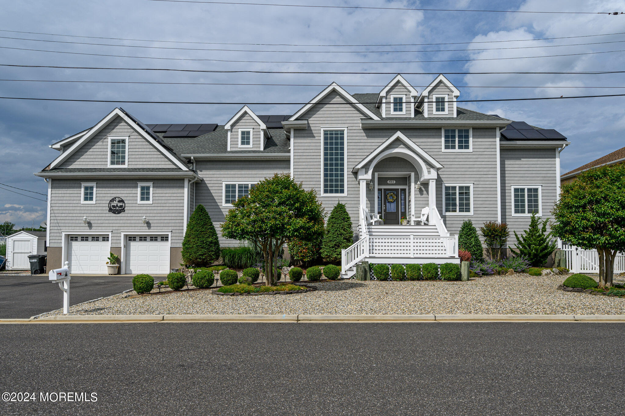 a front view of a house with a garden