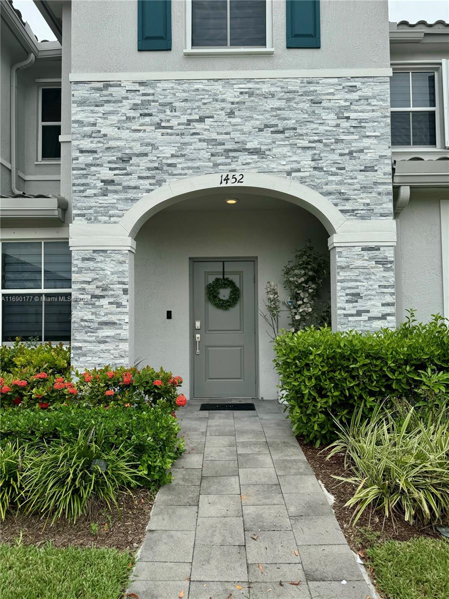 a front view of a house with garden