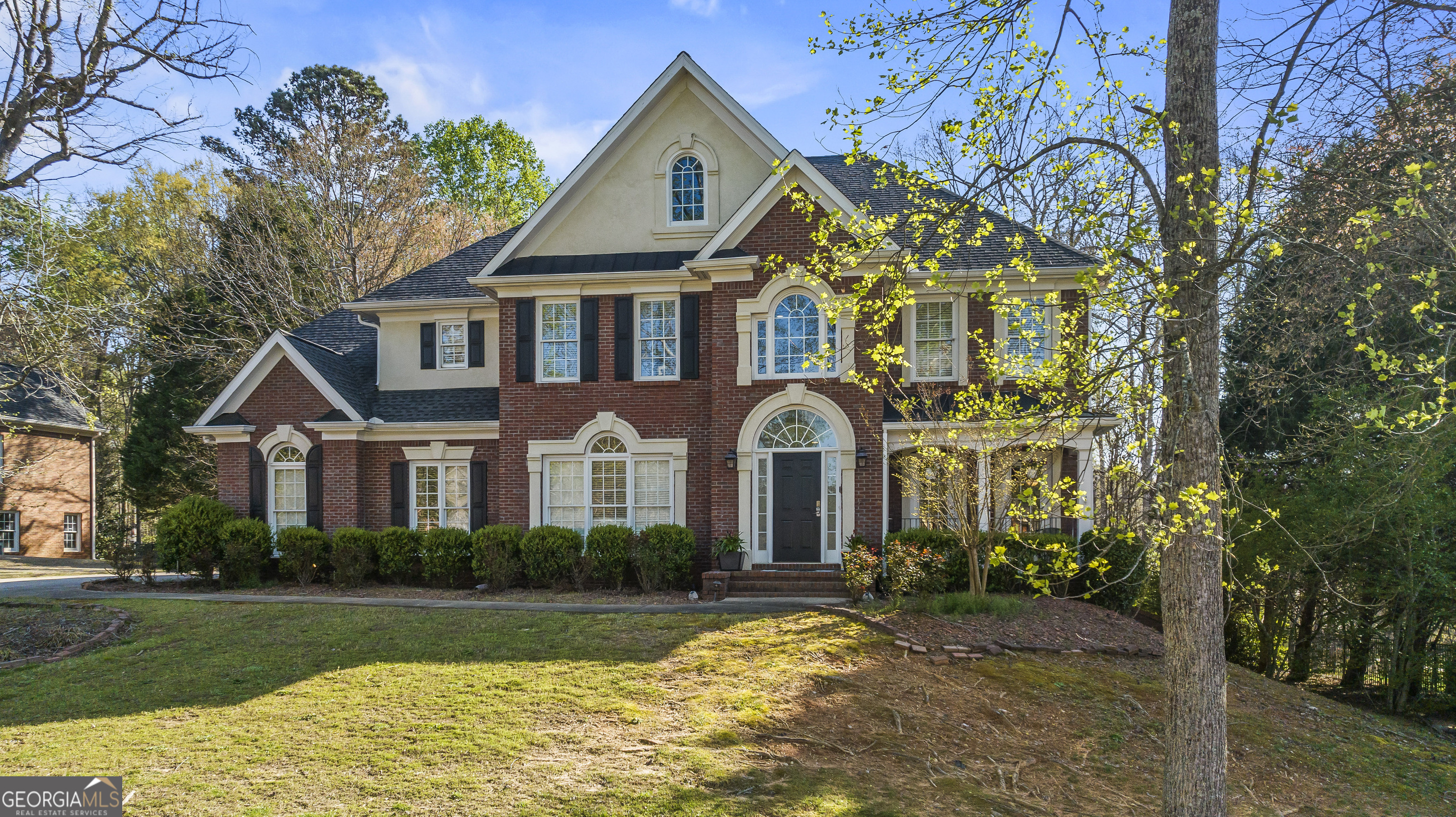 a front view of a house with garden