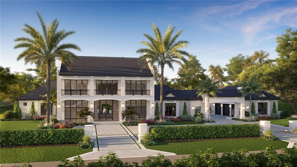 a front view of a house with a yard and palm tree