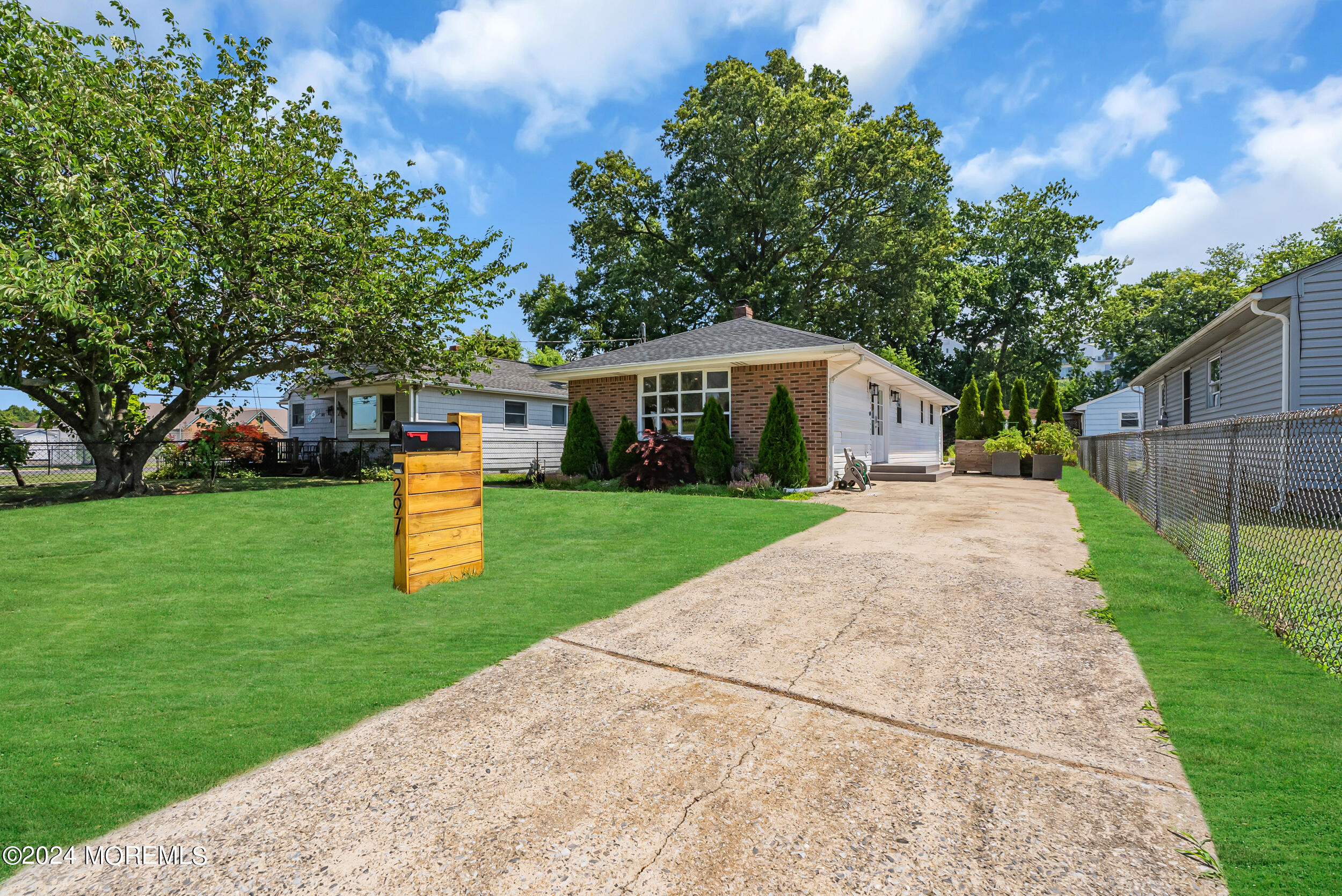 a front view of house with yard and green space