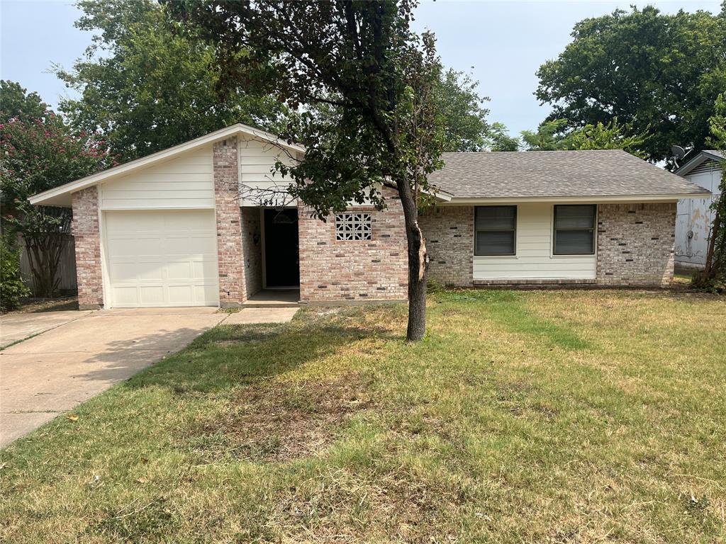 a front view of house with yard and trees