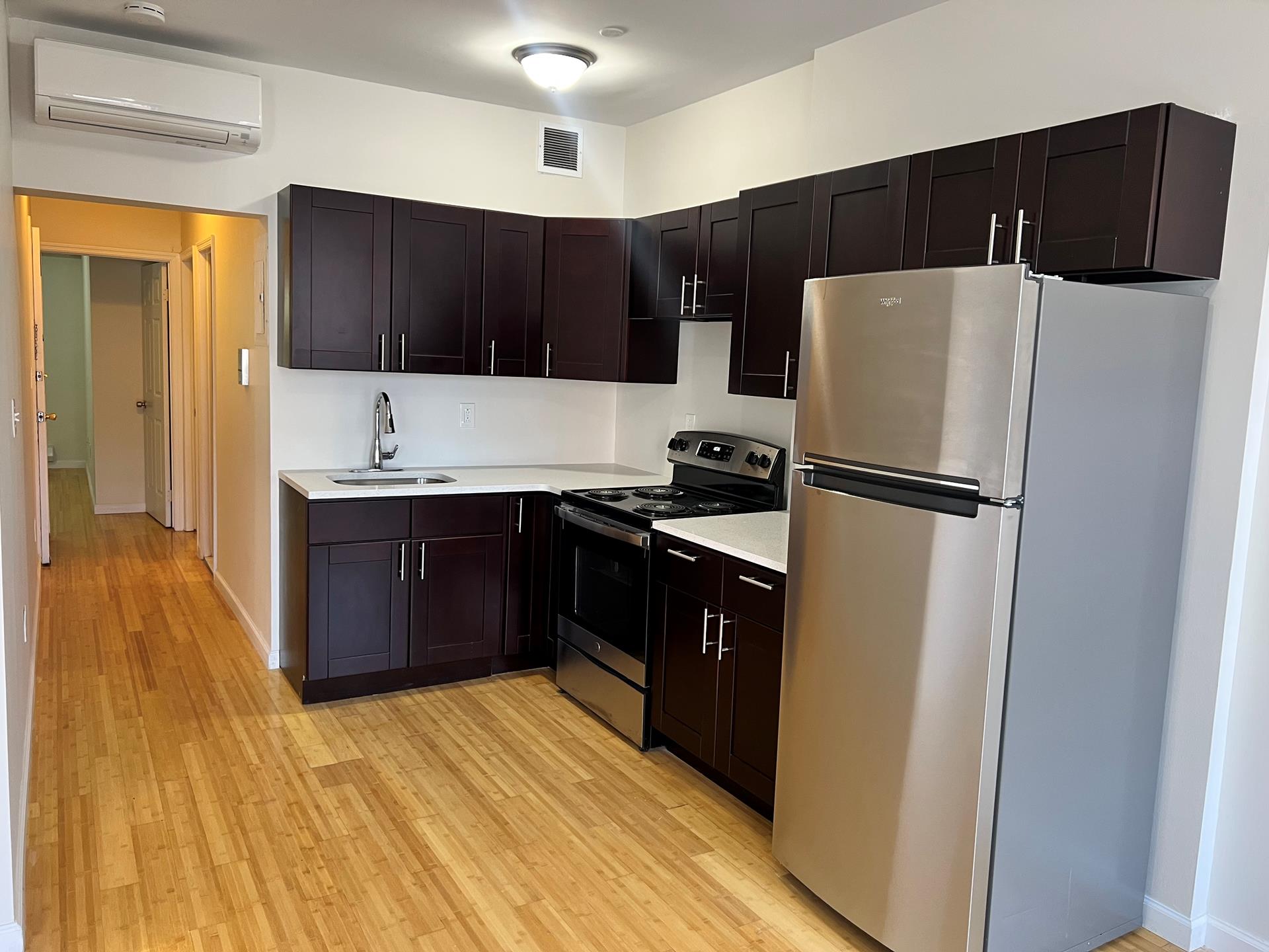 a kitchen with stainless steel appliances a refrigerator and a stove top oven