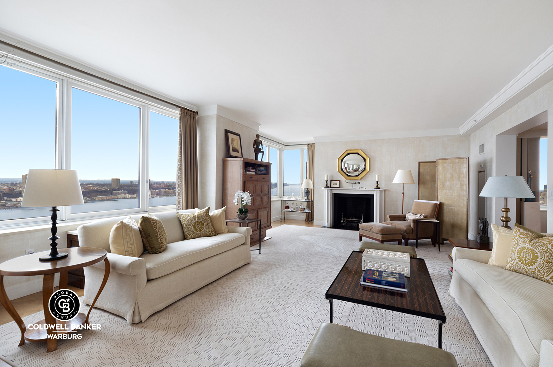 a living room with furniture a fireplace and a lamp