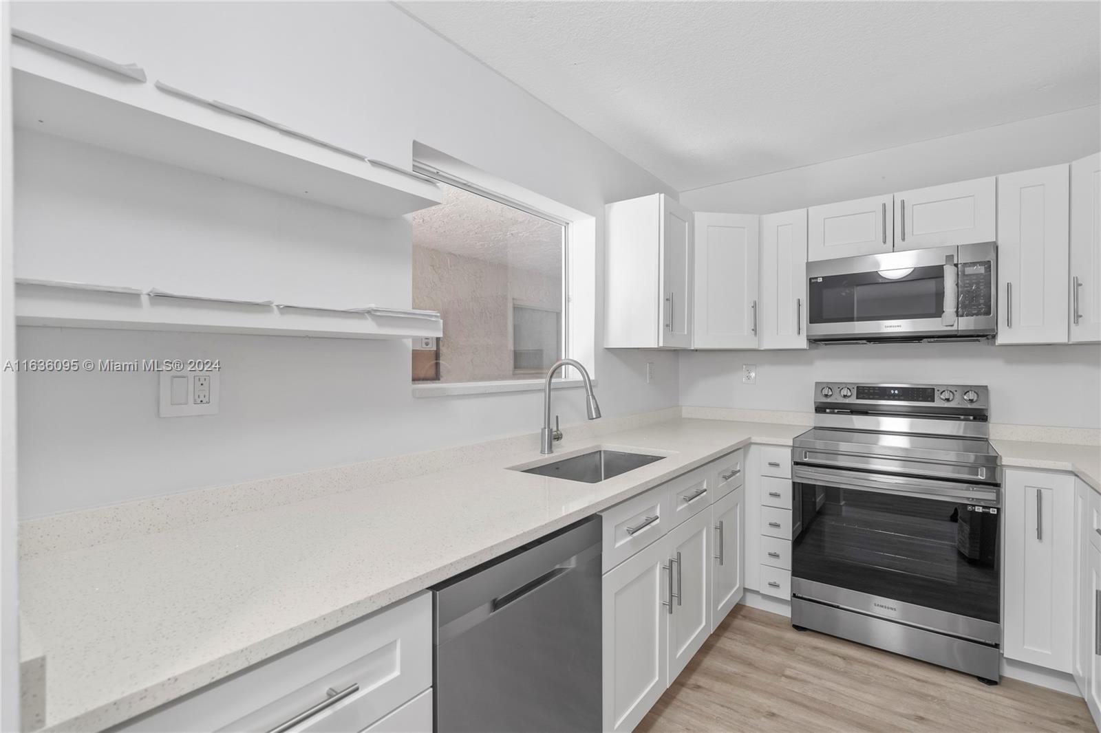 a kitchen with a sink stove and microwave