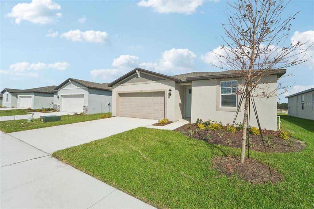 a front view of a house with a yard and garage