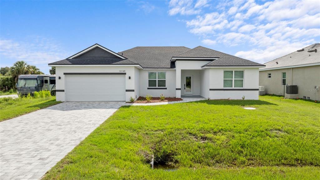 a front view of house with yard and green space