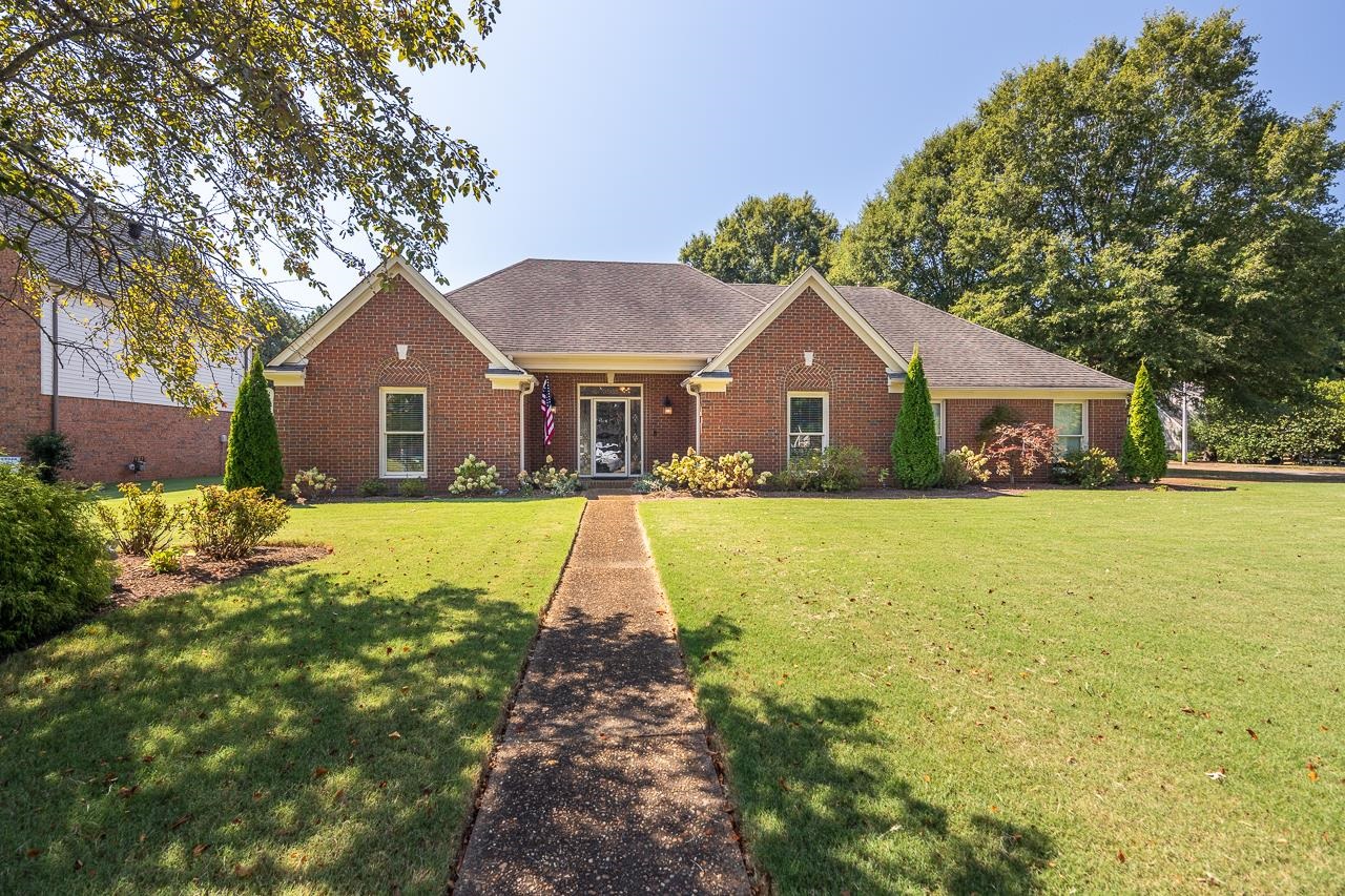 a front view of house with yard and green space