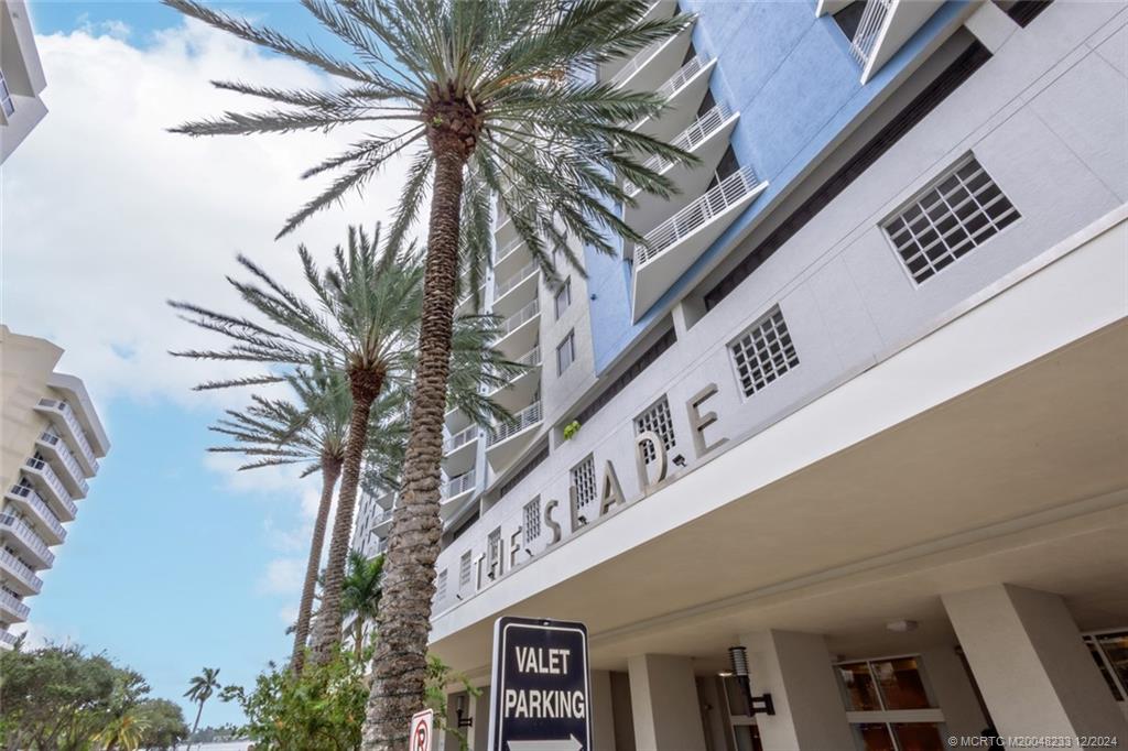 a building with a palm tree in front of it