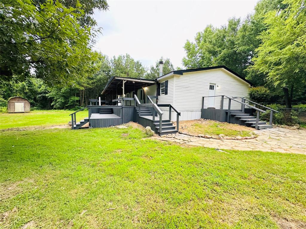 a view of a house with swimming pool and sitting area