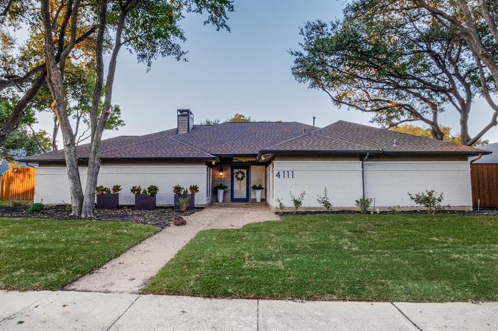 a front view of house with yard and trees