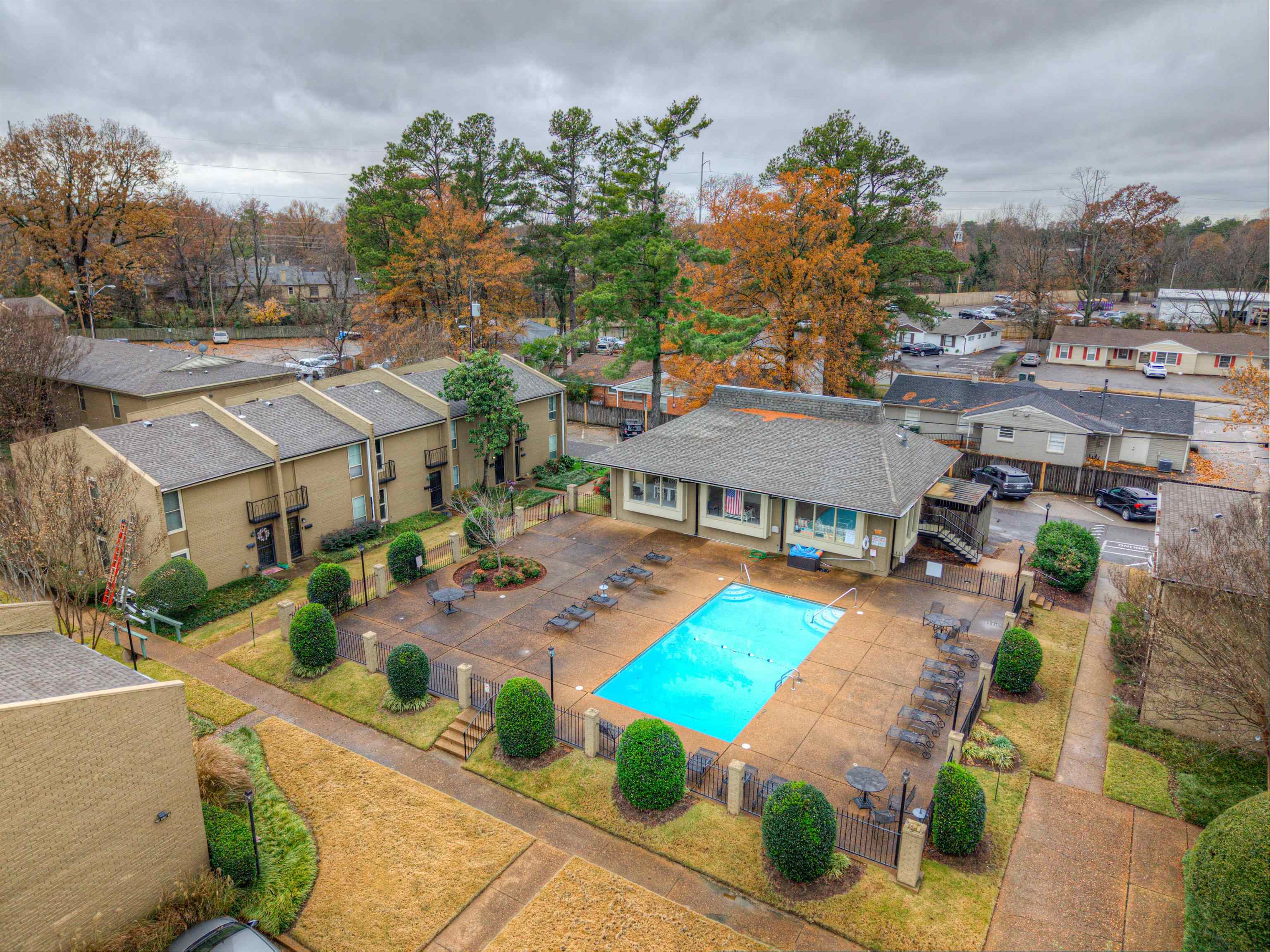 an aerial view of a house with swimming pool and furniture