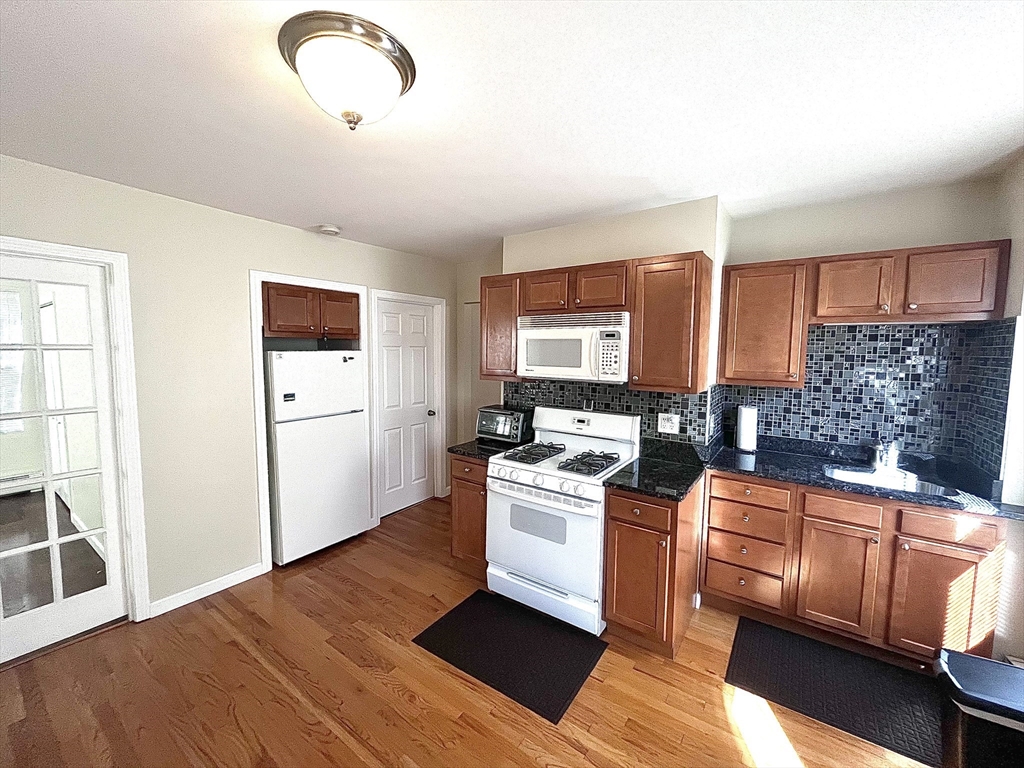 a kitchen with a stove top oven sink and cabinets