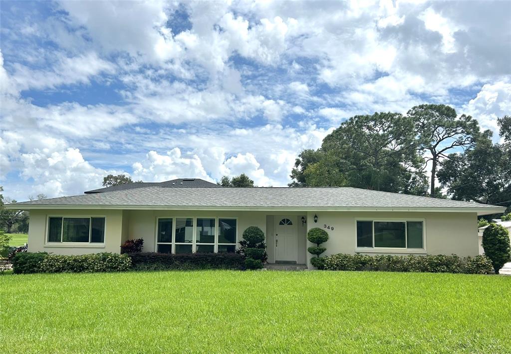 a front view of house with yard and green space