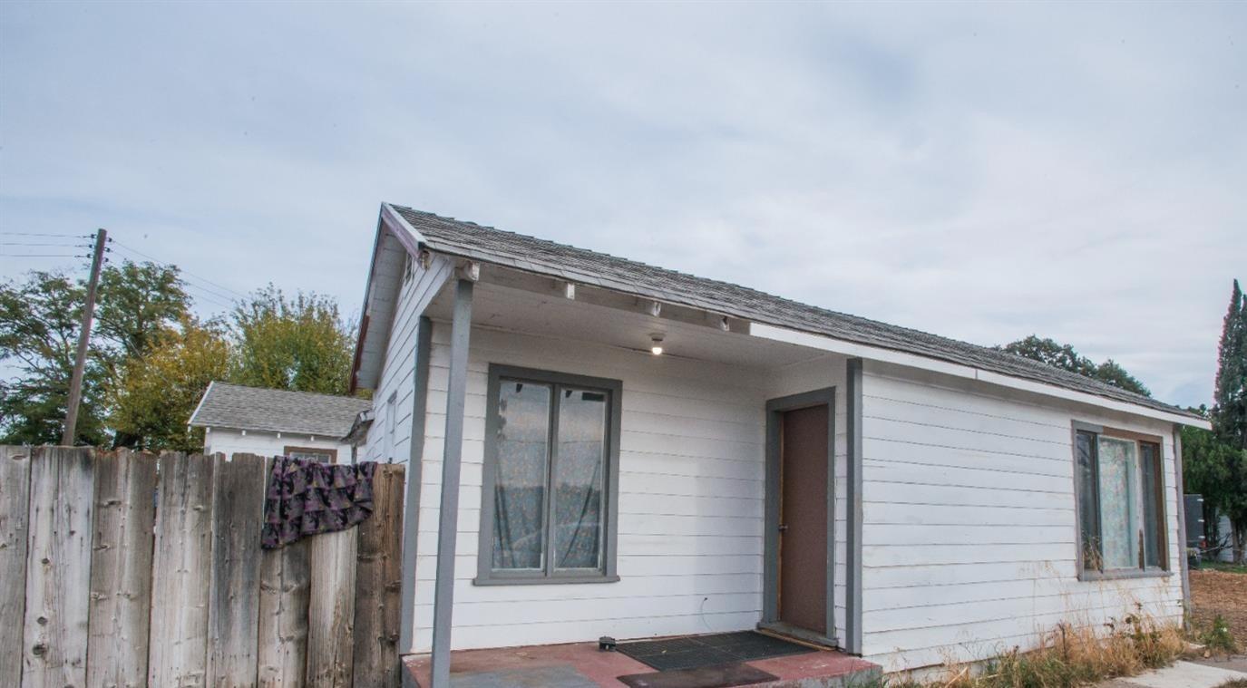 a view of house with backyard and deck