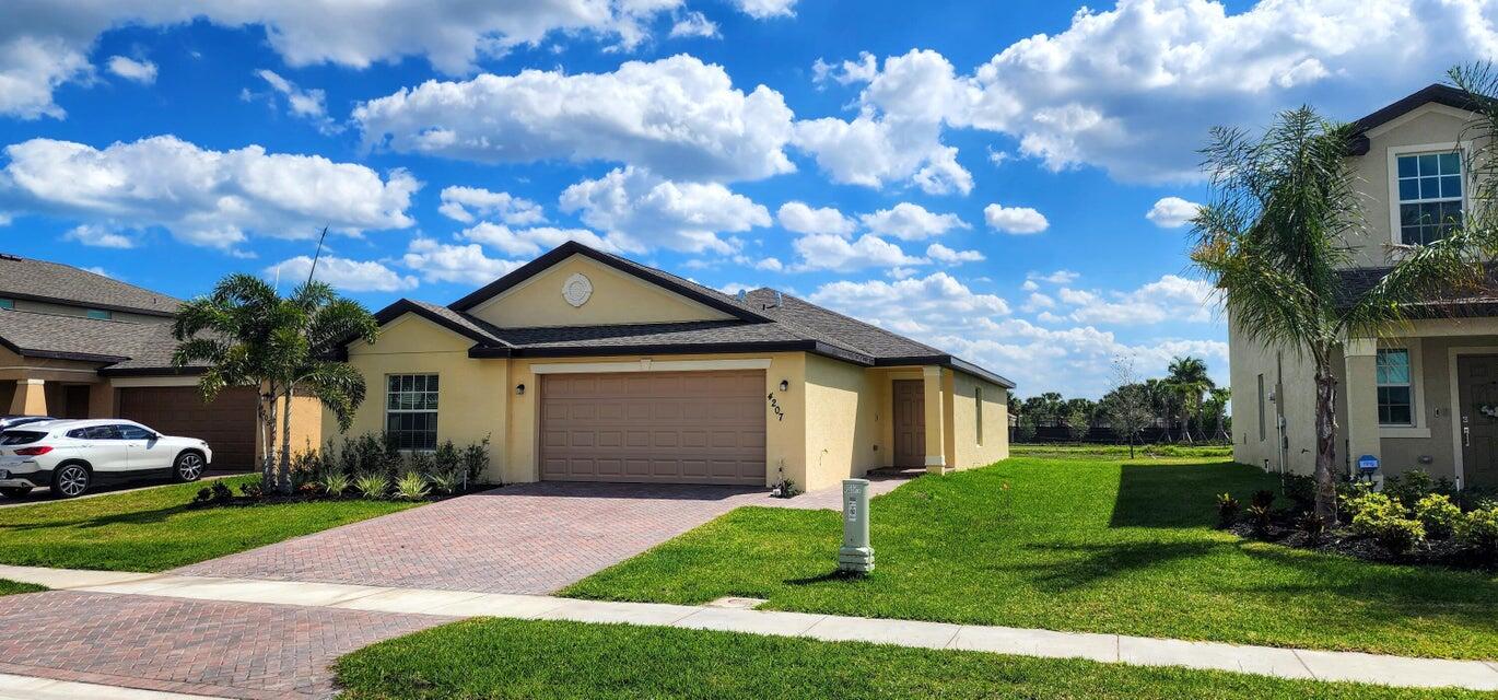 a front view of house with yard and green space