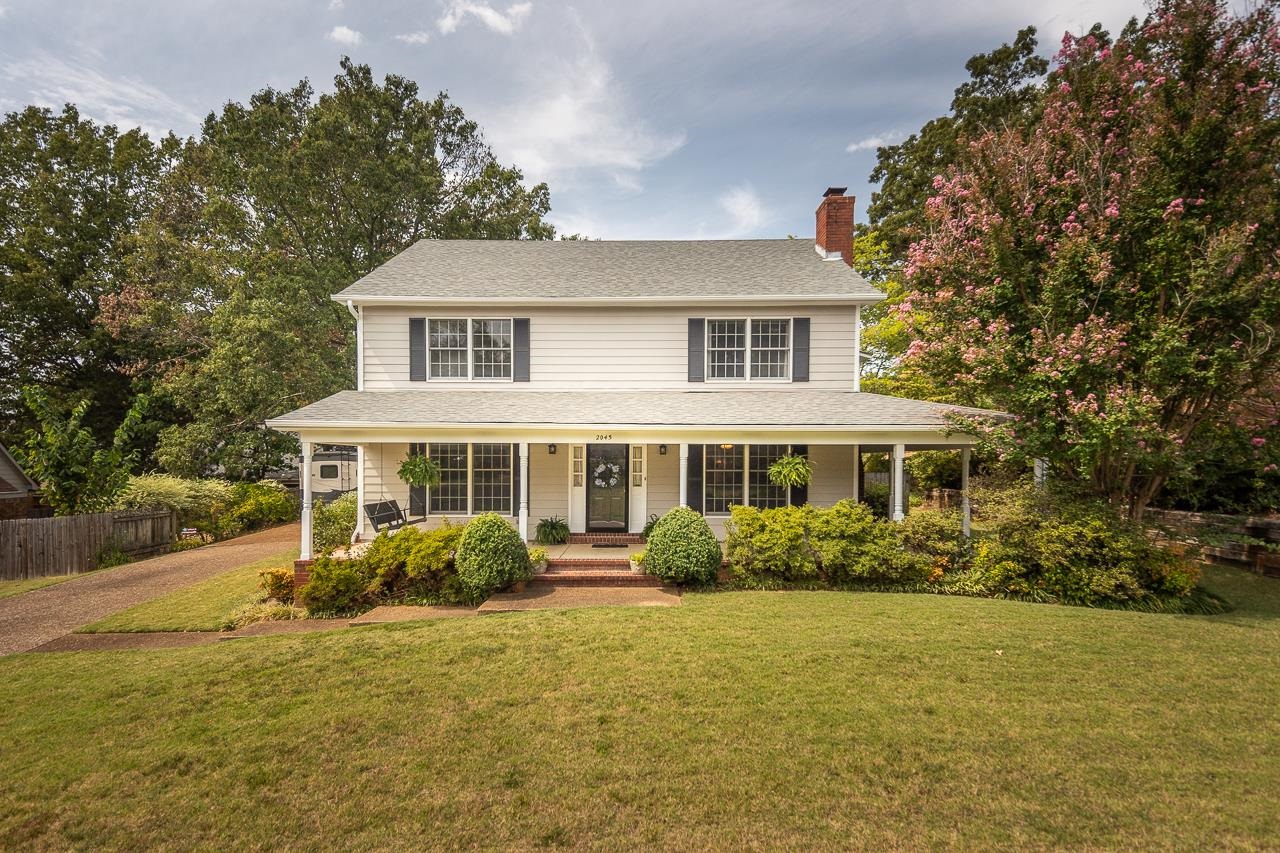 View of front of home featuring a front yard and covered porch