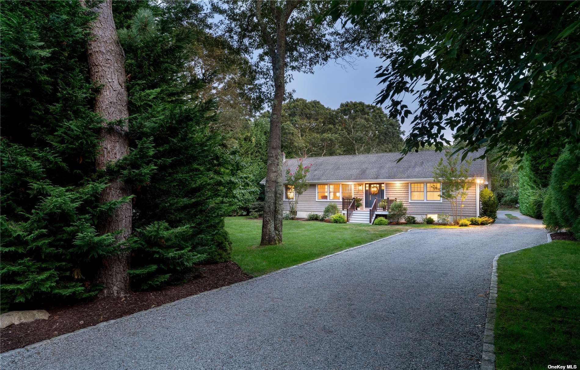 a view of a house with a yard and tree s