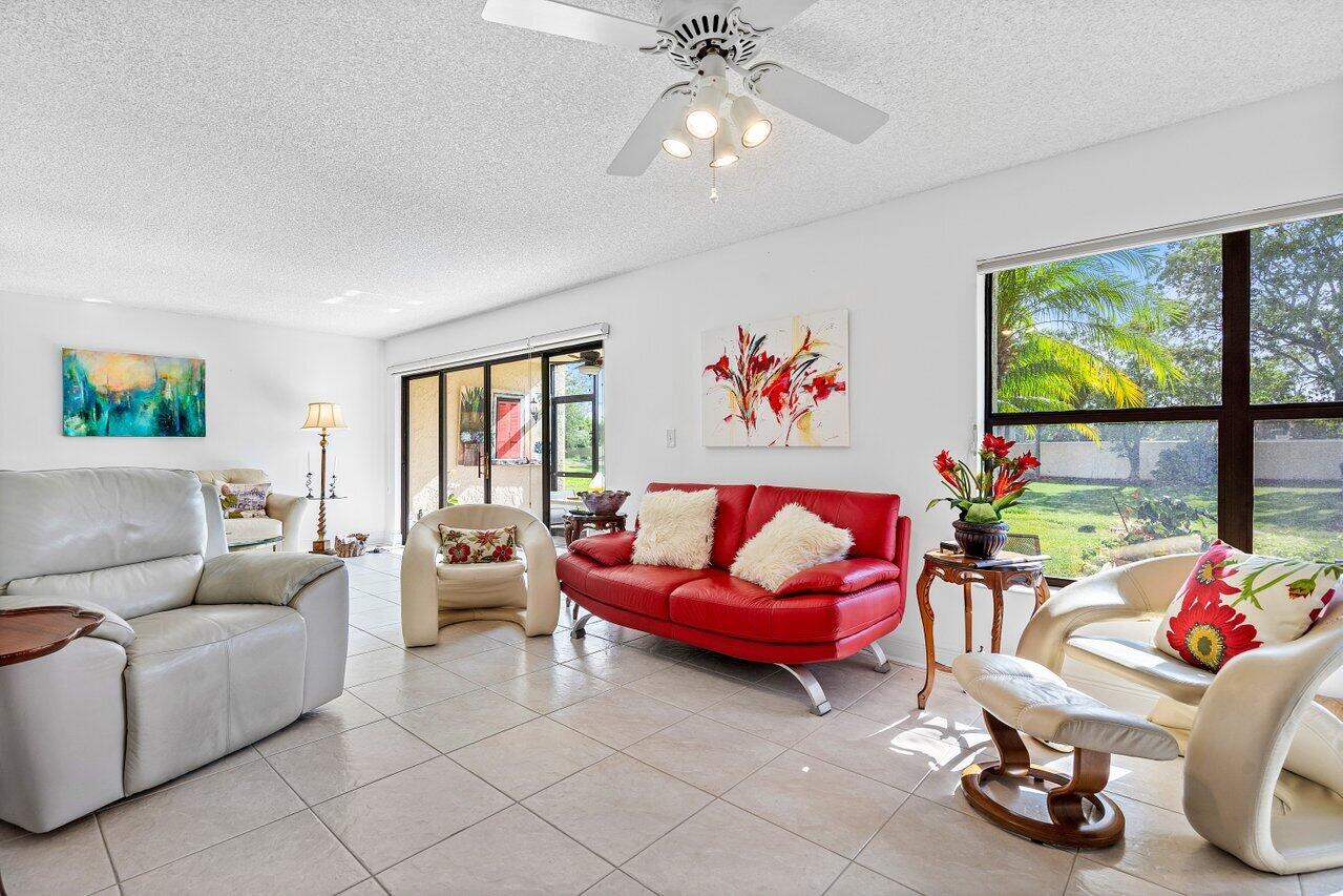 a living room with furniture a flat screen tv and a window