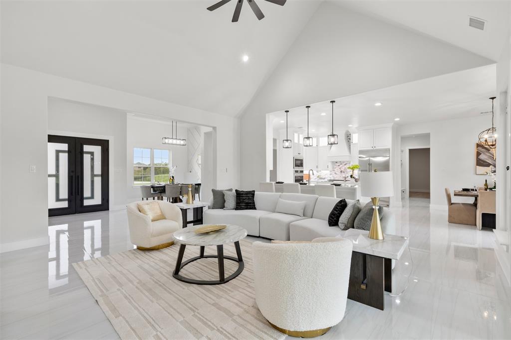 a living room with furniture white walls and kitchen view