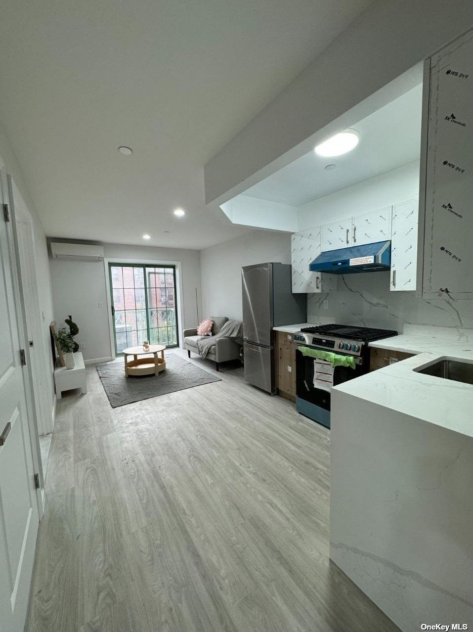 a large white kitchen with stainless steel appliances