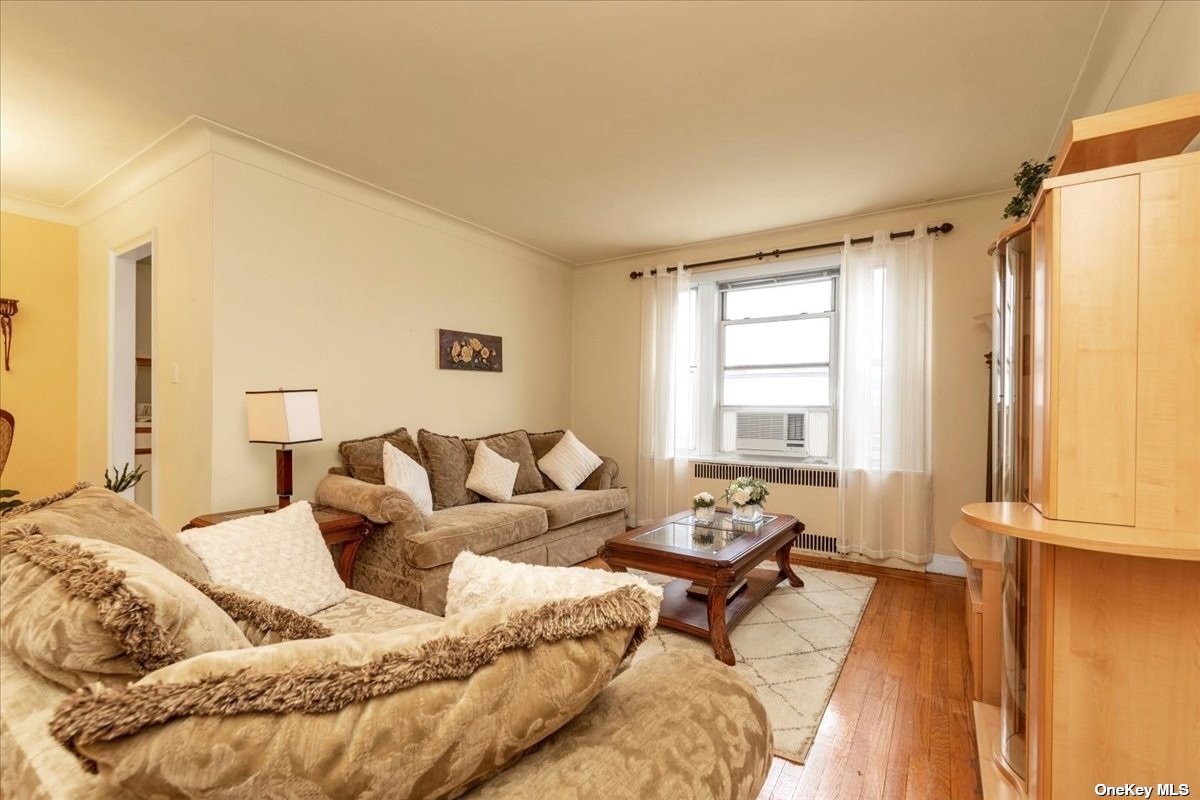 a living room with a bed furniture and a window