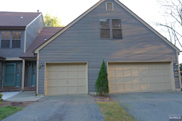 a front view of a house with garage