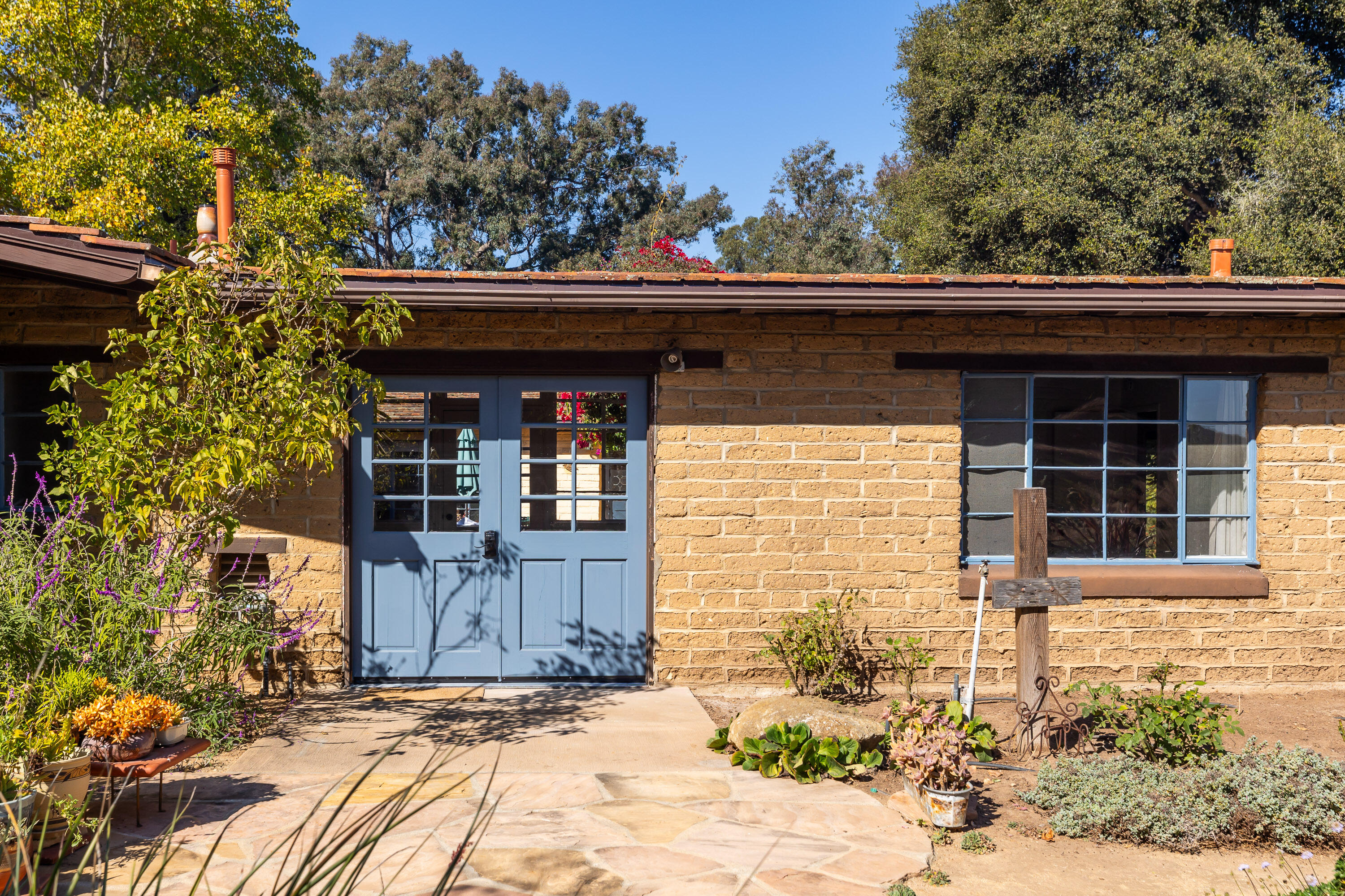 a front view of a house with garden