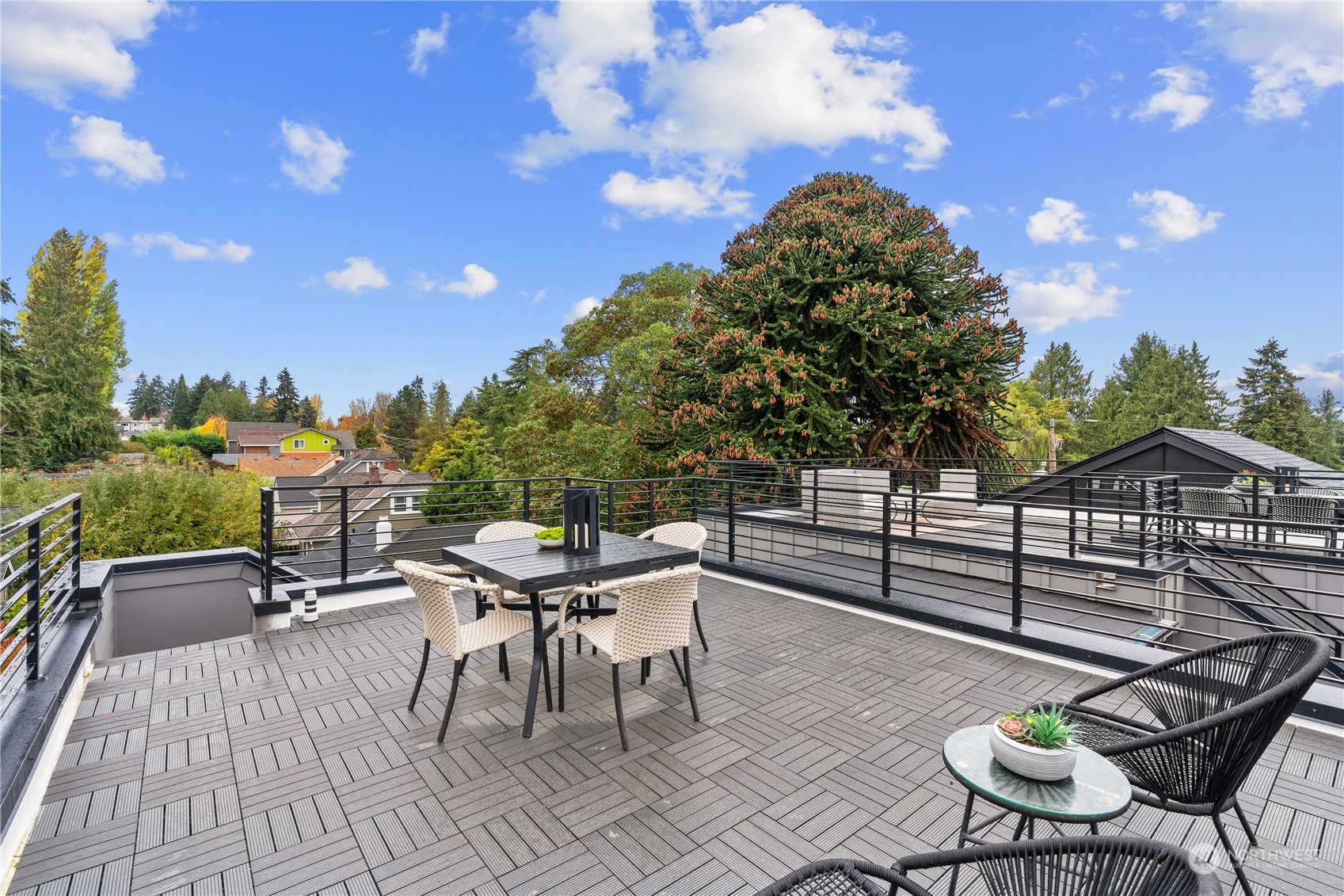 a view of a terrace with furniture and a garden