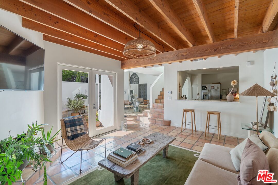 a living room with furniture and a dining table