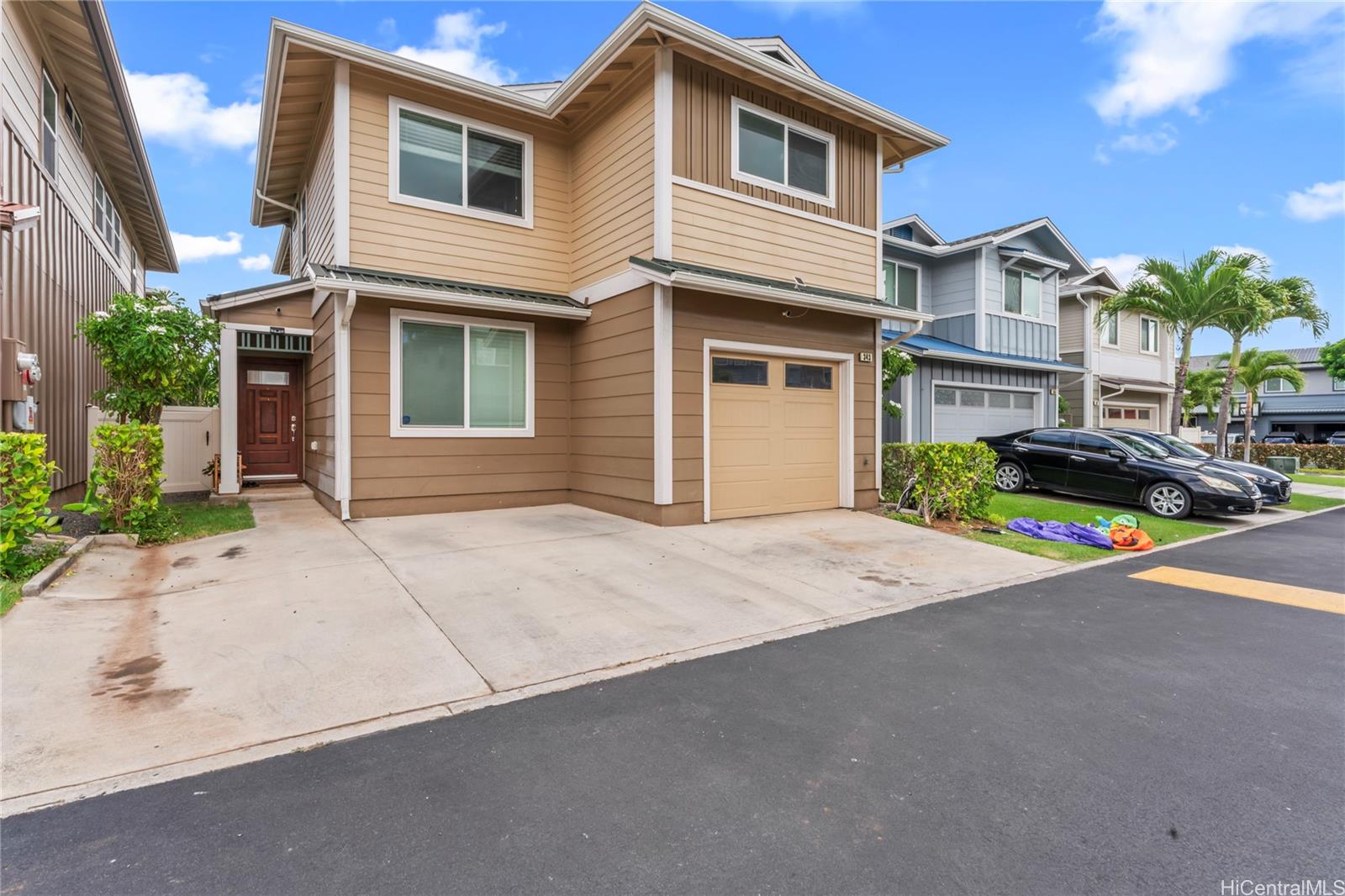 a front view of a house with a yard and garage